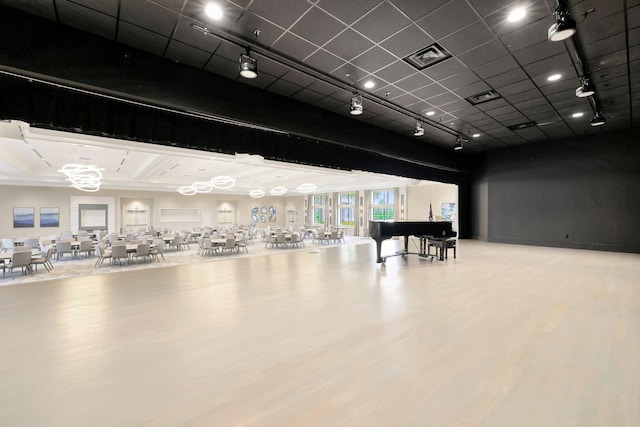 miscellaneous room featuring hardwood / wood-style flooring and rail lighting