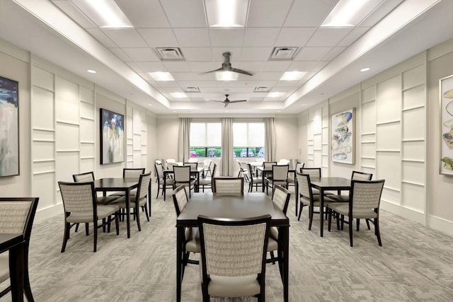 dining room featuring ceiling fan, a paneled ceiling, and a tray ceiling