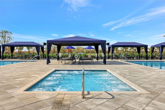 view of swimming pool with a gazebo and a patio area