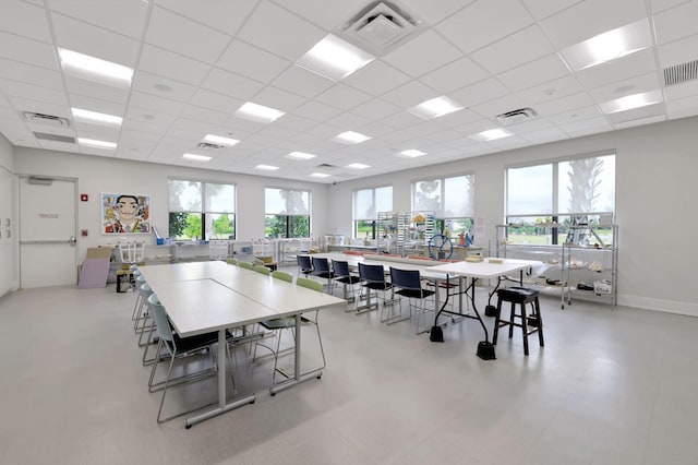 dining space with a drop ceiling