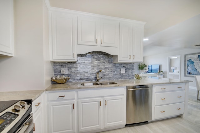 kitchen with white cabinetry, stainless steel appliances, decorative backsplash, and sink