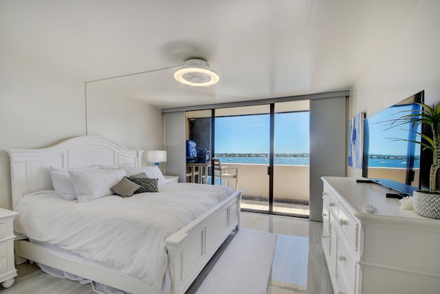 bedroom with ceiling fan, light hardwood / wood-style floors, access to outside, and floor to ceiling windows