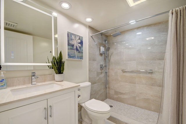 bathroom with vanity, toilet, and curtained shower