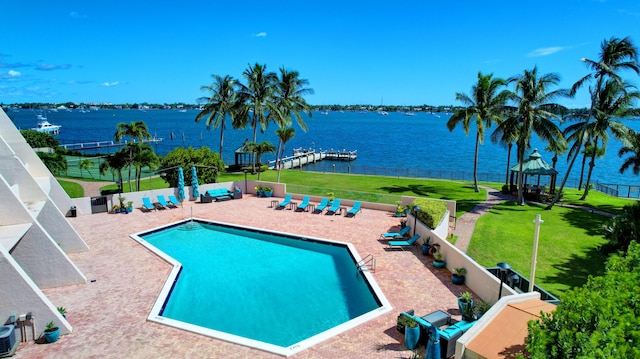 view of pool with a patio area, a gazebo, a yard, and a water view