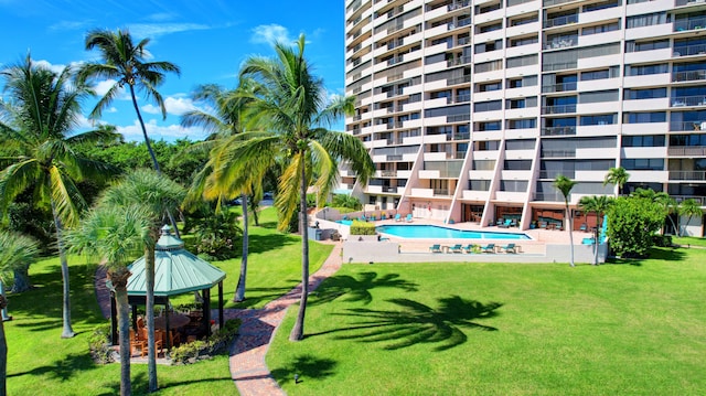 view of pool with a patio area and a lawn