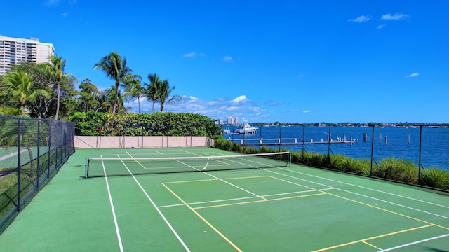 view of tennis court with a water view