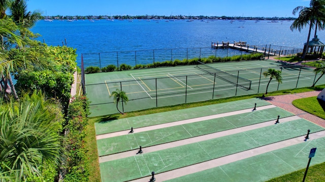 view of tennis court featuring a water view