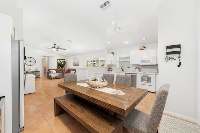 tiled dining space with sink and ceiling fan