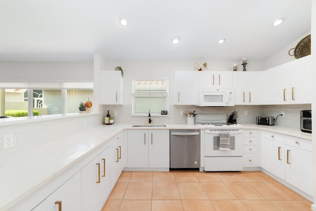 kitchen featuring white cabinetry, sink, and white appliances