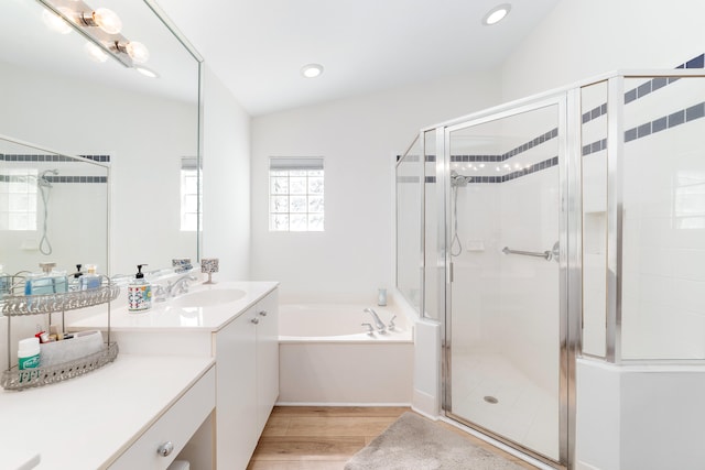 bathroom with shower with separate bathtub, lofted ceiling, hardwood / wood-style flooring, and vanity