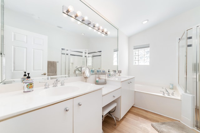 bathroom featuring hardwood / wood-style flooring, vanity, plus walk in shower, and lofted ceiling