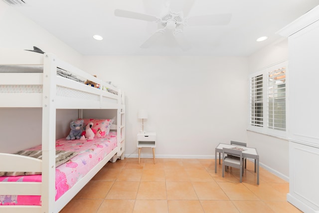 tiled bedroom featuring ceiling fan