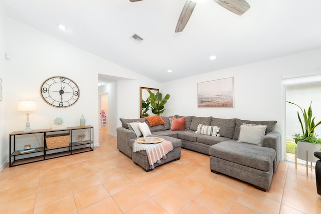 living room with ceiling fan, light tile patterned floors, and vaulted ceiling