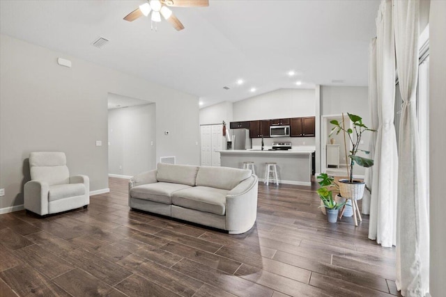 541 SW Nadell Ct, Port Saint Lucie, FL 34953 - living room with dark wood-style floors, a ceiling fan, recessed lighting, lofted ceiling, and baseboards