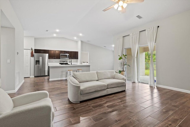 541 SW Nadell Ct, Port Saint Lucie, FL 34953 - living area featuring lofted ceiling, dark wood-style flooring, a ceiling fan, recessed lighting, and baseboards