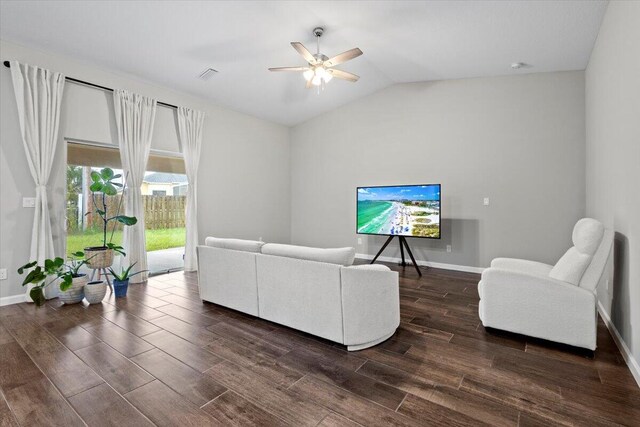 living room featuring lofted ceiling, dark hardwood / wood-style floors, and ceiling fan