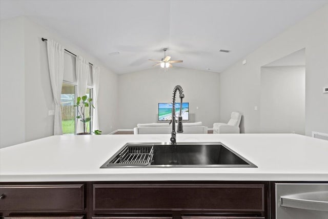 kitchen with sink, ceiling fan, dark brown cabinetry, and vaulted ceiling