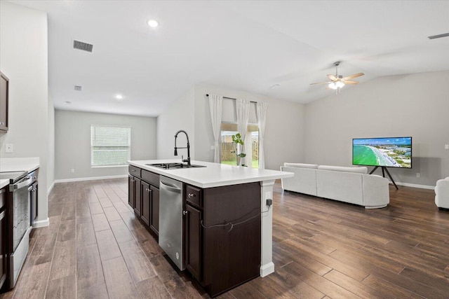 kitchen with sink, an island with sink, dark wood-type flooring, and stainless steel appliances