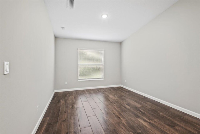 empty room with dark hardwood / wood-style floors