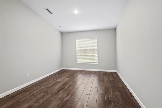 unfurnished room featuring dark hardwood / wood-style floors