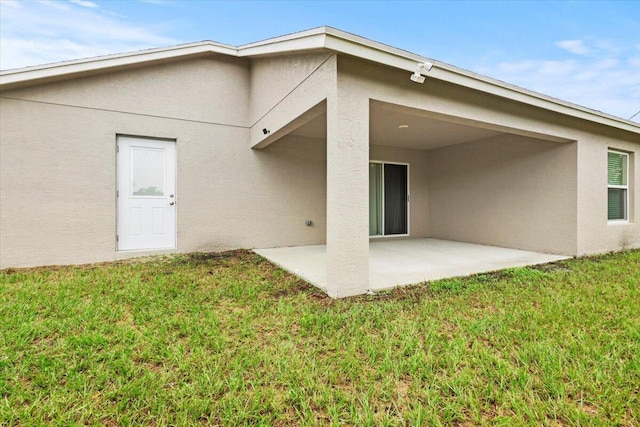 back of property with a patio and a yard