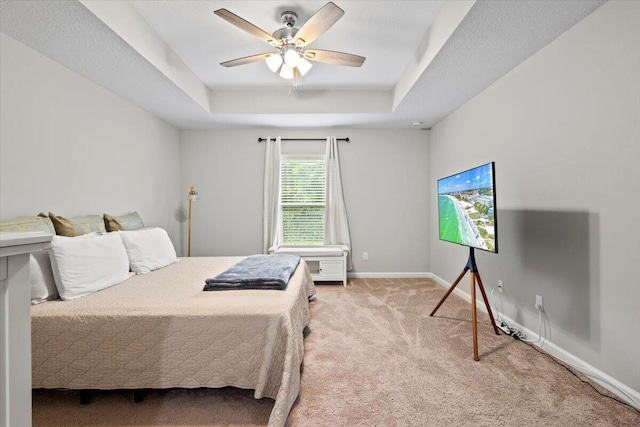 541 SW Nadell Ct, Port Saint Lucie, FL 34953 - carpeted bedroom featuring a tray ceiling, baseboards, and ceiling fan