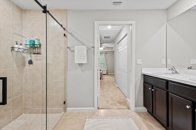 bathroom featuring vanity, walk in shower, ceiling fan, and tile patterned flooring