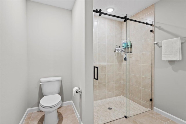 541 SW Nadell Ct, Port Saint Lucie, FL 34953 - bathroom featuring a shower stall, toilet, tile patterned flooring, and baseboards