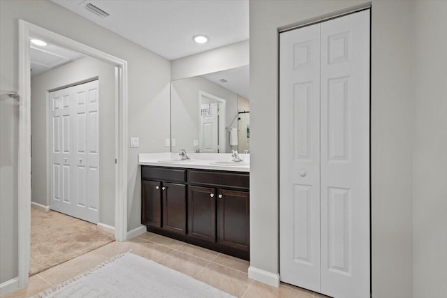 541 SW Nadell Ct, Port Saint Lucie, FL 34953 - bathroom with a closet, double vanity, baseboards, and tile patterned flooring