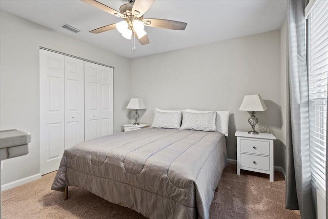 carpeted bedroom with a closet and ceiling fan