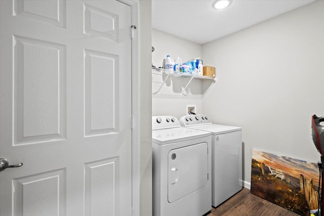 washroom with dark wood-type flooring and washer and clothes dryer