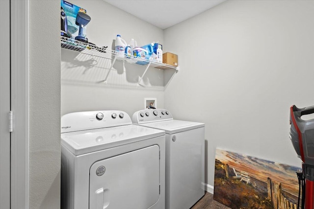 541 SW Nadell Ct, Port Saint Lucie, FL 34953 - laundry area featuring washing machine and clothes dryer and wood finished floors
