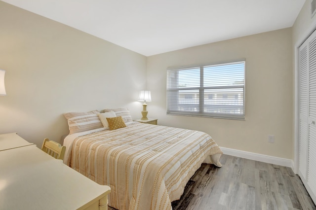 bedroom featuring a closet and light wood-type flooring