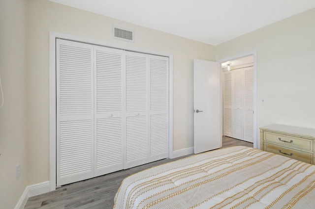 bedroom featuring hardwood / wood-style floors and a closet