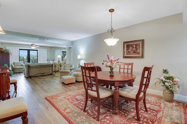 dining room with light hardwood / wood-style flooring and ceiling fan