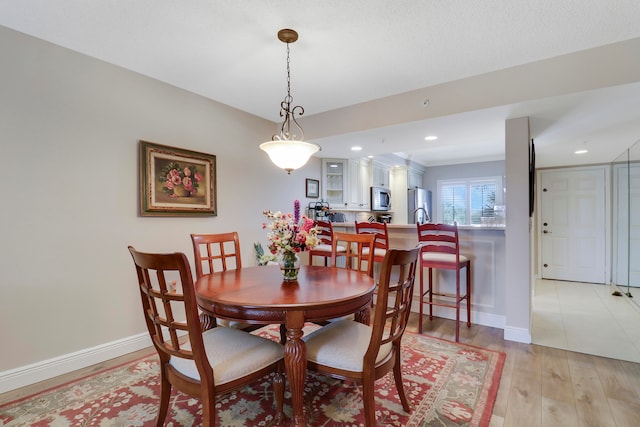 dining space featuring light hardwood / wood-style flooring