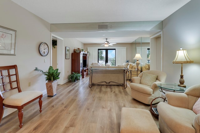 living room with light wood-type flooring and ceiling fan