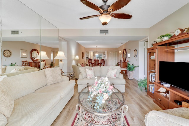 living room with light wood-type flooring and ceiling fan