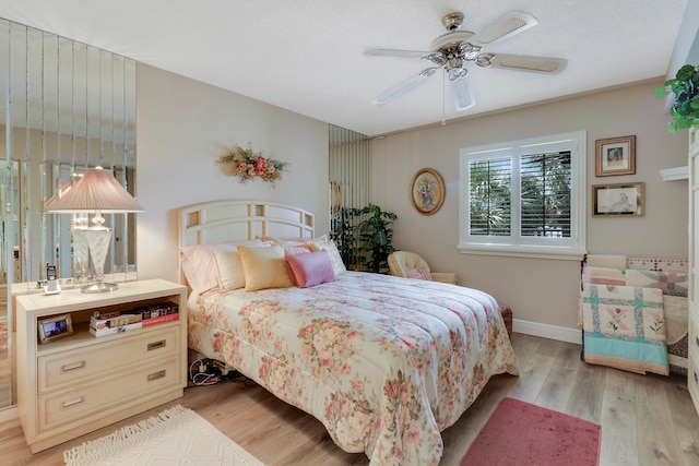 bedroom featuring ceiling fan and light hardwood / wood-style flooring