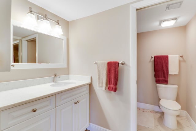 bathroom with vanity, tile patterned floors, and toilet