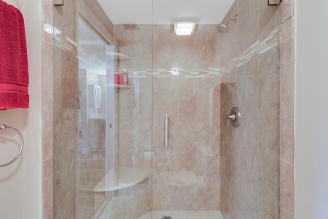 bathroom with a shower with shower door