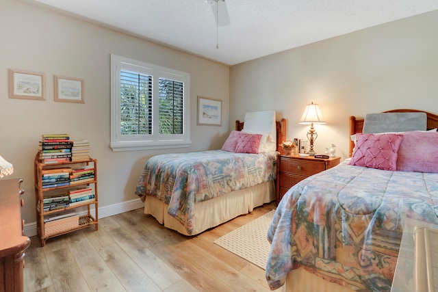 bedroom featuring light hardwood / wood-style floors and ceiling fan