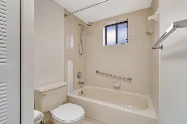 bathroom featuring toilet and tiled shower / bath combo