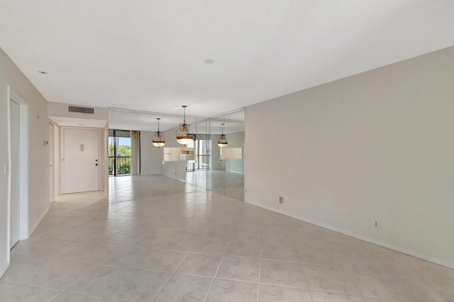 spare room with light tile patterned floors