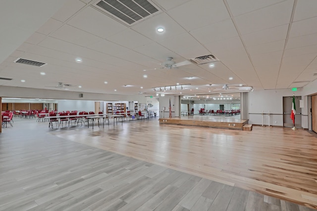 workout area with light wood-type flooring and ceiling fan