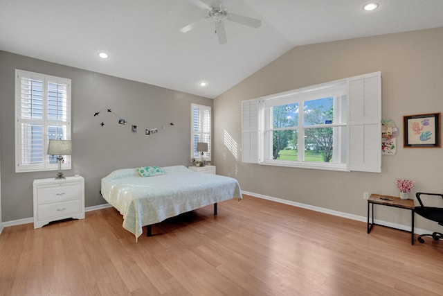 bedroom with light hardwood / wood-style flooring, multiple windows, lofted ceiling, and ceiling fan