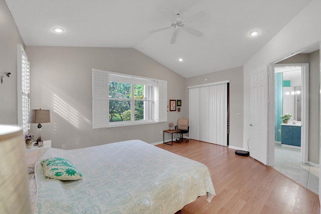 bedroom with connected bathroom, lofted ceiling, hardwood / wood-style flooring, and ceiling fan