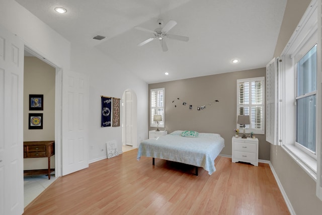 bedroom featuring lofted ceiling, light hardwood / wood-style flooring, and ceiling fan