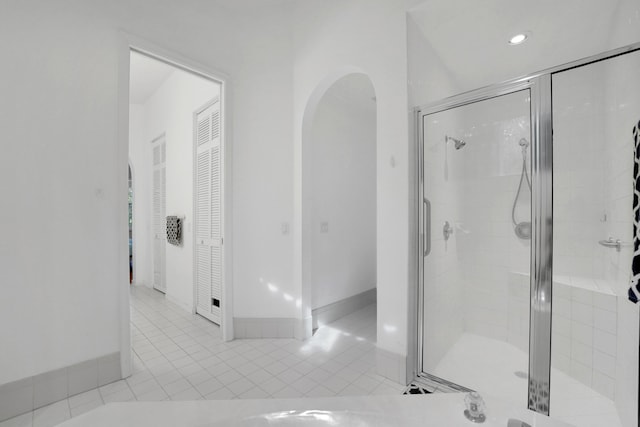 bathroom with tile patterned flooring and walk in shower