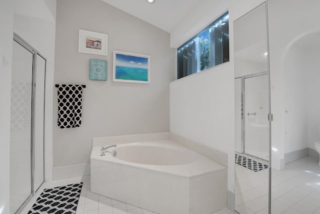 bathroom featuring lofted ceiling, shower with separate bathtub, and tile patterned flooring